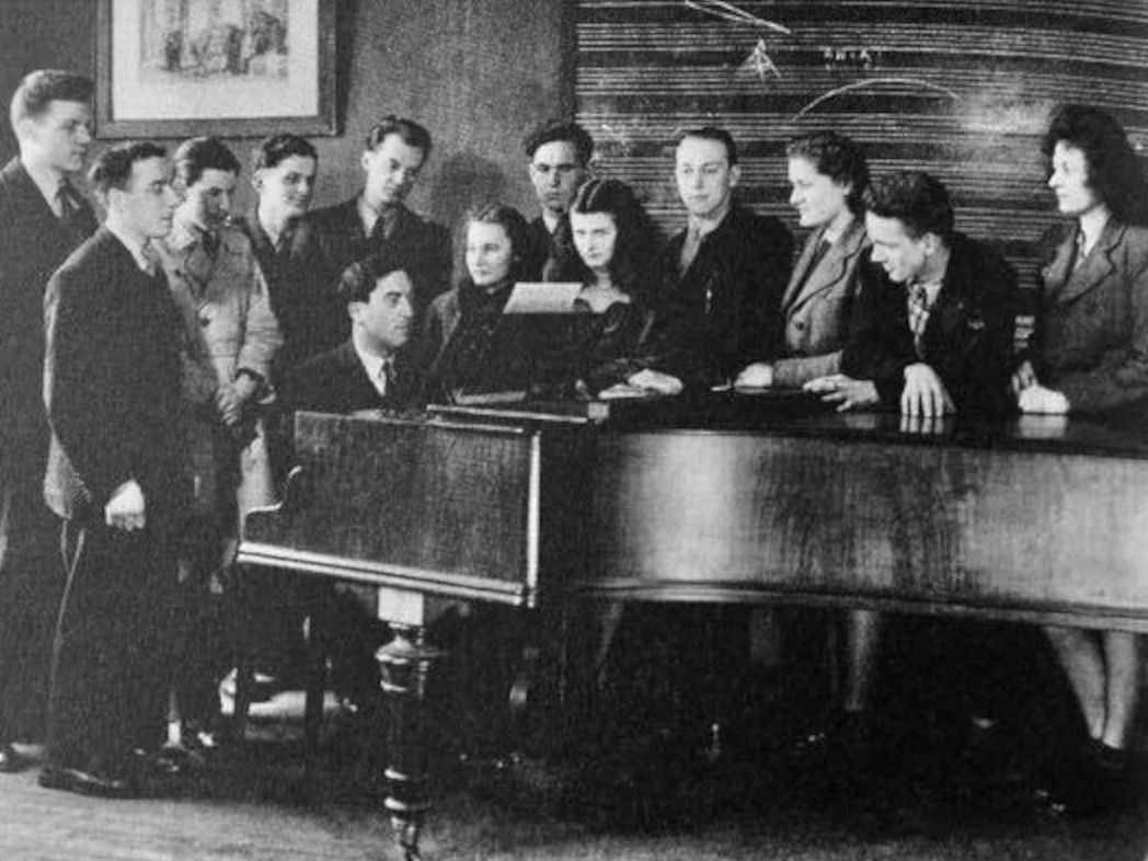 Maurice Duruflé seated at the piano.